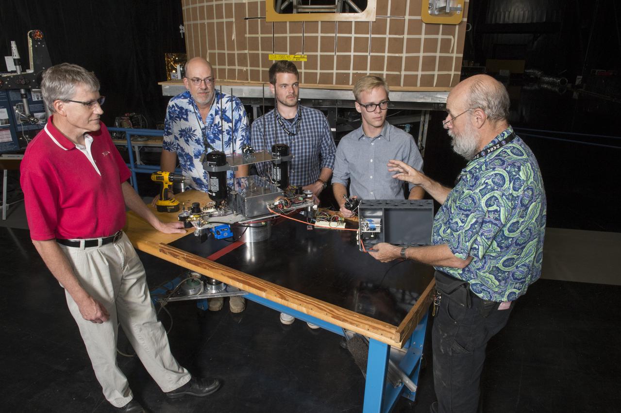 Electric Sail (E-Sail) Tether Team Discusses 6U CubeSat Test Article and Tether Deployment System  (Right to left:  Tom Bryan, Davis Hunter (student intern), Jonathan MacArthur (student intern), Charles Cowen, Mike Tinker)