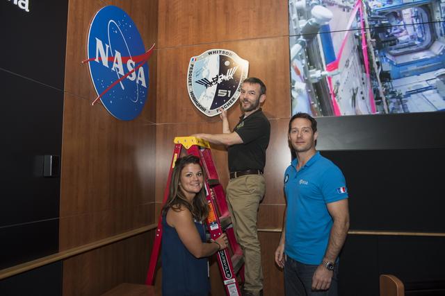 NASA image: Astronaut Thomas Pesquet hangs Expedition 50/51 plaque.