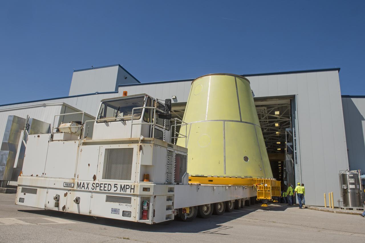 A NASA KAMAG transporter moves the Space Launch System’s launch vehicle stage adapter (LVSA) to an area where spray-on foam insulation will be applied. The LVSA recently completed manufacturing on a 30 foot welding tool at NASA’s Marshall Space Flight Center in Huntsville, Al. The LVSA will be coated with insulation that will protect it during it’s trip to space. The LVSA provides structural support and connects the core stage and the interim cryogenic propulsion stage during the first integrated flight of SLS and Orion.