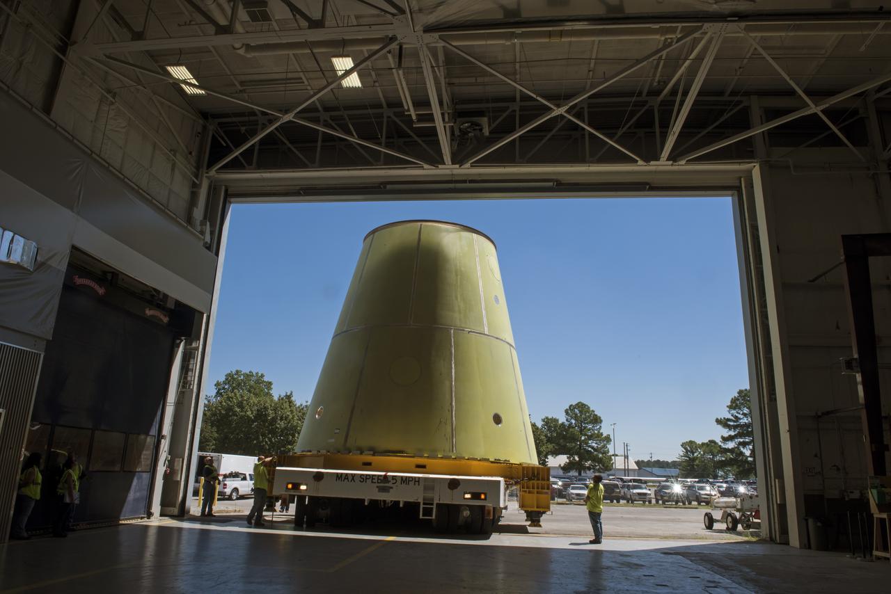 A NASA KAMAG transporter moves the Space Launch System’s launch vehicle stage adapter (LVSA) to an area where spray-on foam insulation will be applied. The LVSA recently completed manufacturing on a 30 foot welding tool at NASA’s Marshall Space Flight Center in Huntsville, Al. The LVSA will be coated with insulation that will protect it during it’s trip to space. The LVSA provides structural support and connects the core stage and the interim cryogenic propulsion stage during the first integrated flight of SLS and Orion.