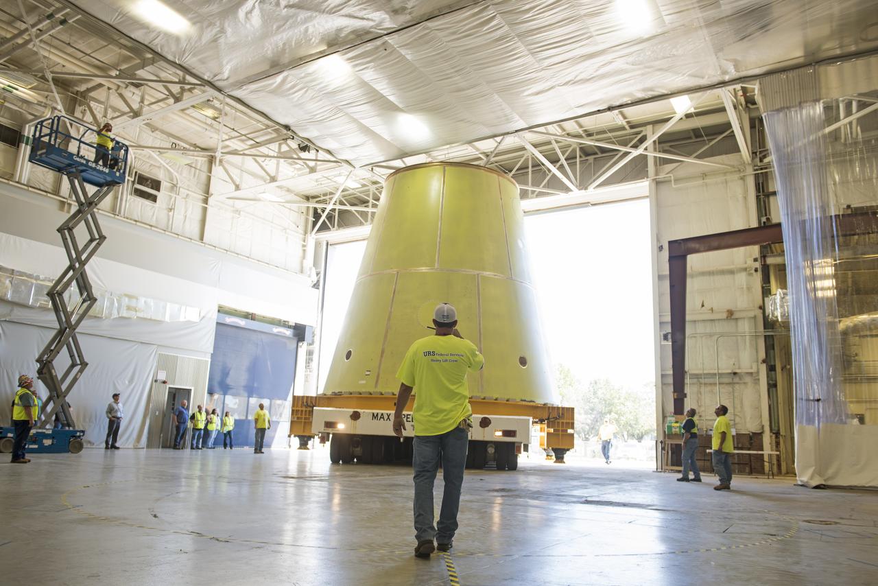 A NASA KAMAG transporter moves the Space Launch System’s launch vehicle stage adapter (LVSA) to an area where spray-on foam insulation will be applied. The LVSA recently completed manufacturing on a 30 foot welding tool at NASA’s Marshall Space Flight Center in Huntsville, Al. The LVSA will be coated with insulation that will protect it during it’s trip to space. The LVSA provides structural support and connects the core stage and the interim cryogenic propulsion stage during the first integrated flight of SLS and Orion.