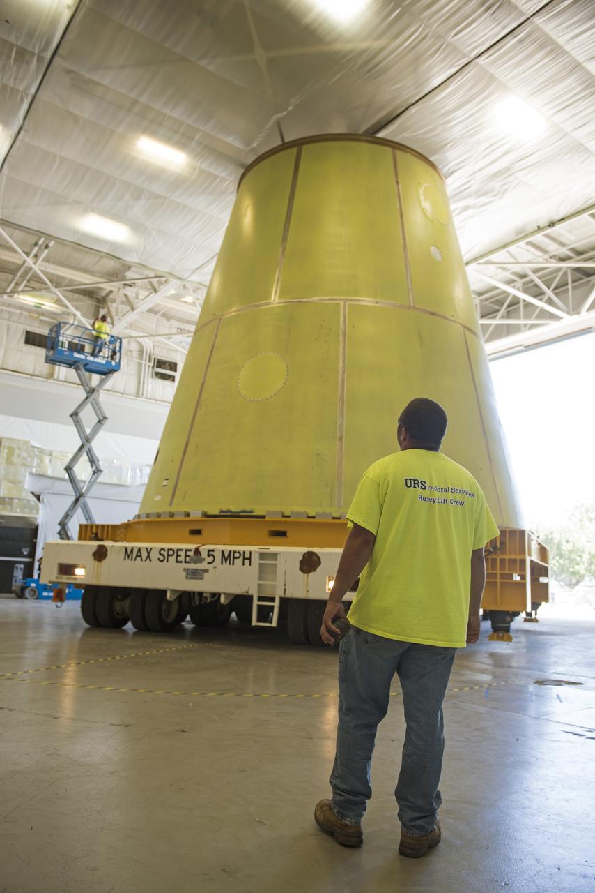 A NASA KAMAG transporter moves the Space Launch System’s launch vehicle stage adapter (LVSA) to an area where spray-on foam insulation will be applied. The LVSA recently completed manufacturing on a 30 foot welding tool at NASA’s Marshall Space Flight Center in Huntsville, Al. The LVSA will be coated with insulation that will protect it during it’s trip to space. The LVSA provides structural support and connects the core stage and the interim cryogenic propulsion stage during the first integrated flight of SLS and Orion.