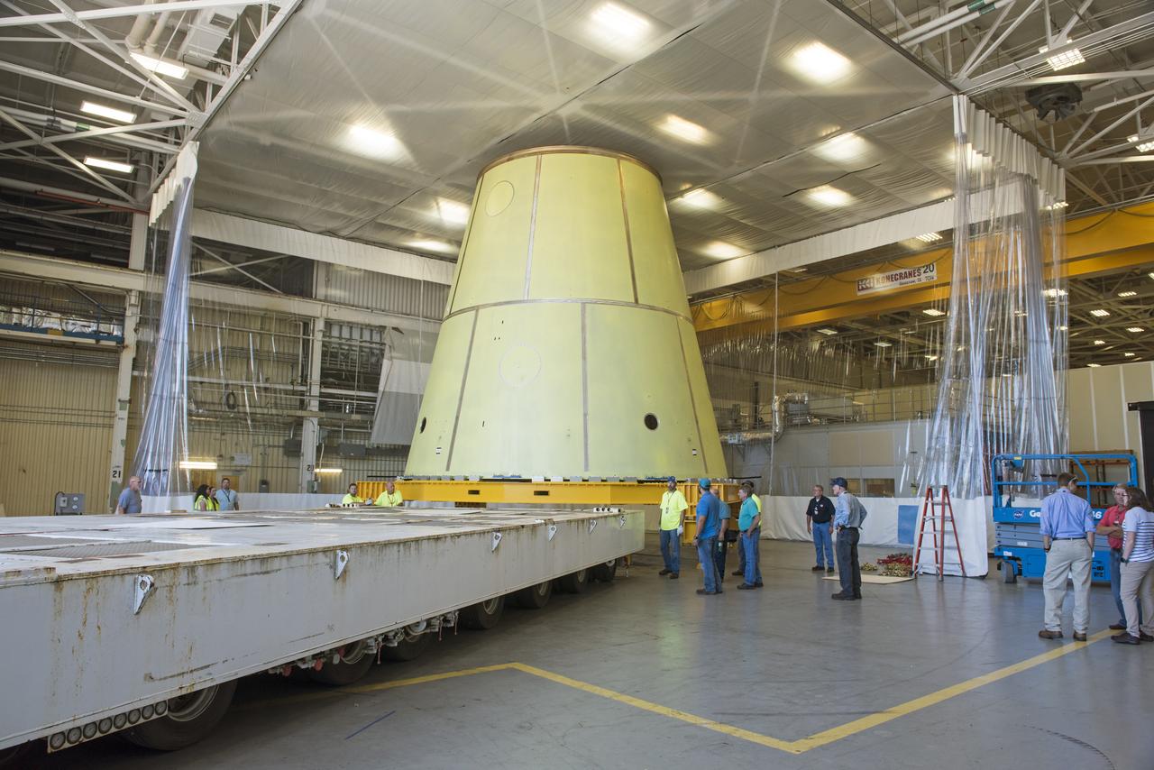 A NASA KAMAG transporter moves the Space Launch System’s launch vehicle stage adapter (LVSA) to an area where spray-on foam insulation will be applied. The LVSA recently completed manufacturing on a 30 foot welding tool at NASA’s Marshall Space Flight Center in Huntsville, Al. The LVSA will be coated with insulation that will protect it during it’s trip to space. The LVSA provides structural support and connects the core stage and the interim cryogenic propulsion stage during the first integrated flight of SLS and Orion.