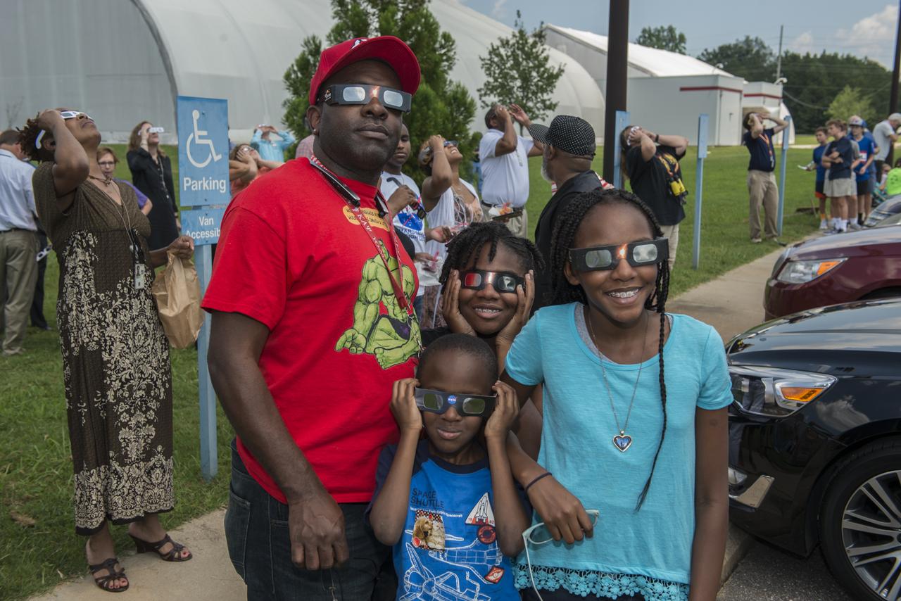Sylvester Dorsey III, avionics lead for the Europa Deorbit Stage Team in Marshall's Engineering Directorate, is joined during Marshall's eclipse-viewing event by his three children, from left, Sylvester IV, Sidney and Sakari. Though Huntsville was south of the path of totality, the Dorseys were among those awestruck by the natural phenomenon. The Huntsville area experienced 97 percent occultation, nearly a complete blocking out of the sun by the orbit of Earth's moon. The next opportunity to view a solar eclipse in the eastern and central United States will occur in April 2024.
