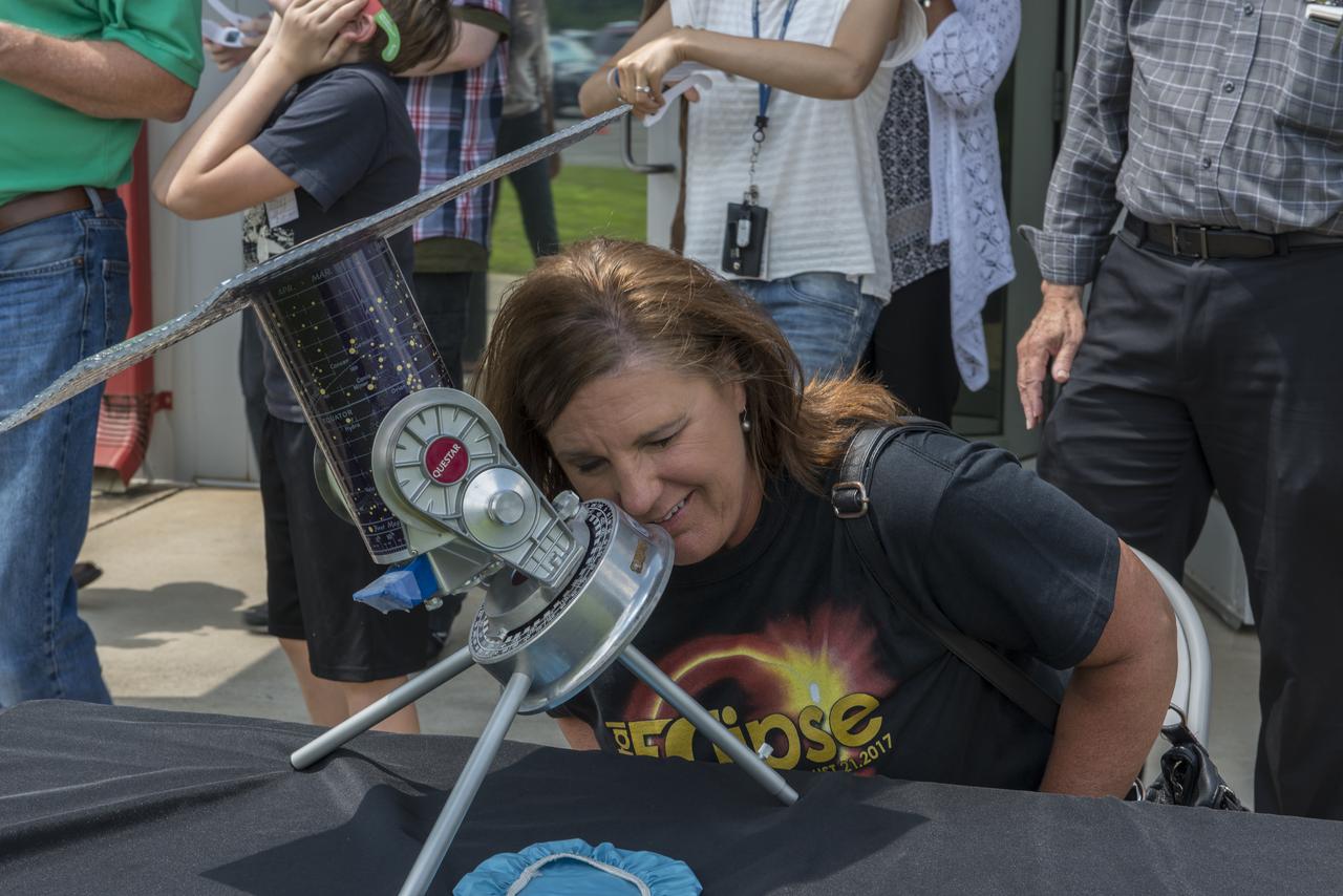Judy Darwin of the Marshall Space Flight Center’s Office of the Chief Information Officer (CIO) views the August 21, 2017 solar eclipse through  the telescope set up for Marshall employees. The Huntsville area experienced 97 percent occultation, nearly a complete blocking out of the sun by the orbit of Earth's moon. The next opportunity to view a solar eclipse in the eastern and central United States will occur in April 2024.