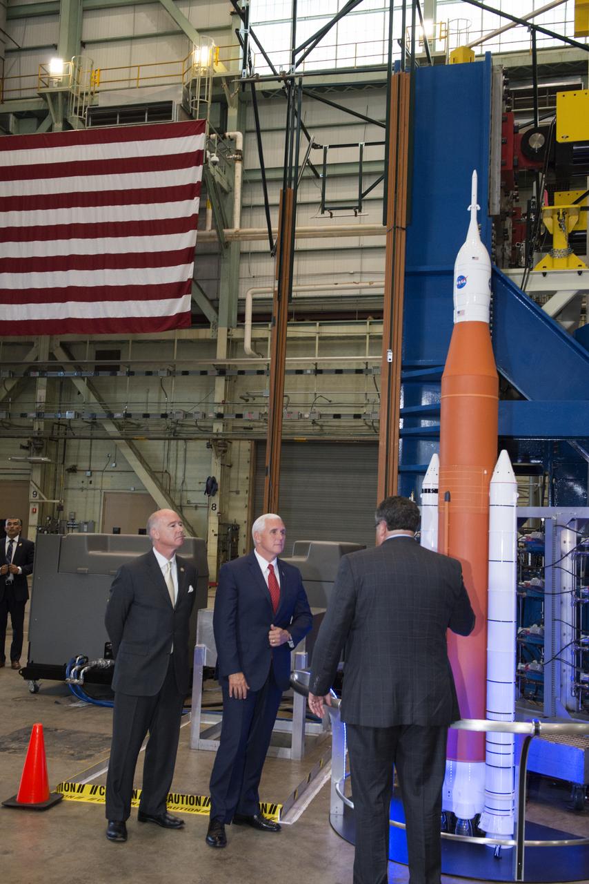 Vice President Mike Pence talks with Marshall Space Flight Center Director Todd May and Congressman Robert Aderholt (R-AL) (left) about NASA’s Space Launch System, the agency’s new deep space rocket. May explained progress being made on the rocket. The Vice President visited NASA Marshall in Huntsville, Alabama on Sept. 25, 2017, and saw SLS core stage engine section test hardware (on the right). The engine section is the bottom of the core stage where the four RS-25 engines attach and produce two million pounds of thrust. The SLS engine section is undergoing structural testing.