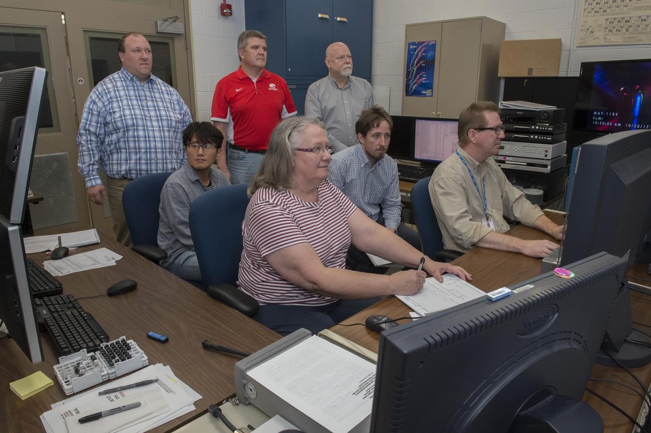 Dr. Douglas Matson, Tufts University, experimenting with an aerodynamic levitator. Dr. Matson, along with students and NASA personnel view data from tests of an aerodynamic levitator in support of his MaterialsLab experiments.  back row: Michael SanSoucie (MSFC EM41), Shawn Reagan (MSFC HP30), and Douglas Matson (Tufts University)  Middle row: Sangho Jeon (Tufts University) and Thomas Leitner (Graz University of Technology) Front row:  Trudy Allen (MSFC EM41) and Glenn Fountain (MSFC EM41)