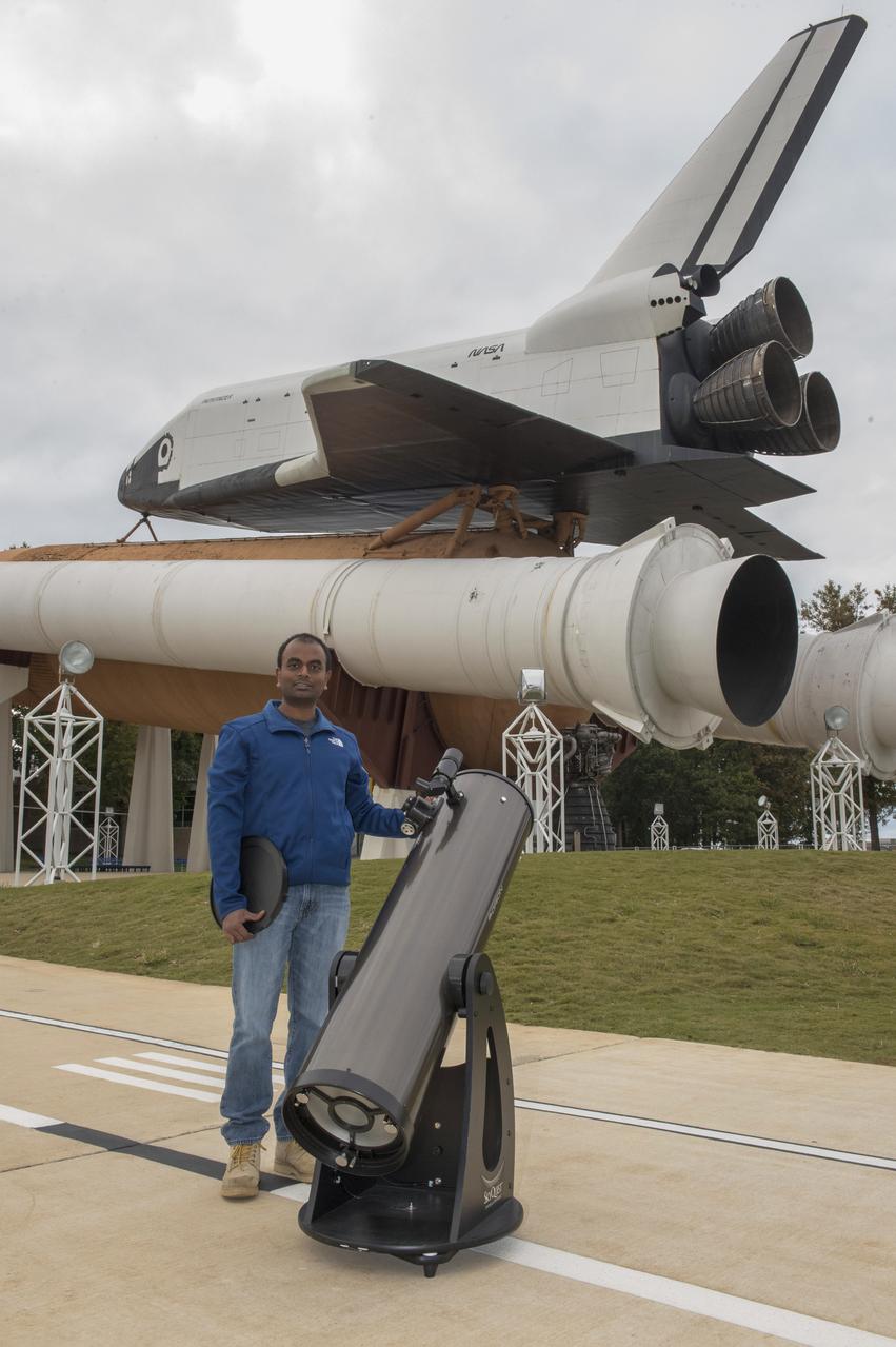 Marshall engineer Naveen Vetcha with his telescope. The event, hosted by the Planetary Missions Program at NASA's Marshall Space Flight Center, encourages observation and appreciation of the Moon and its connection to NASA planetary science and exploration, as well as our cultural and personal connections to it. Children attending the event had the opportunity to participate in planetary, science-based, hands-on activities