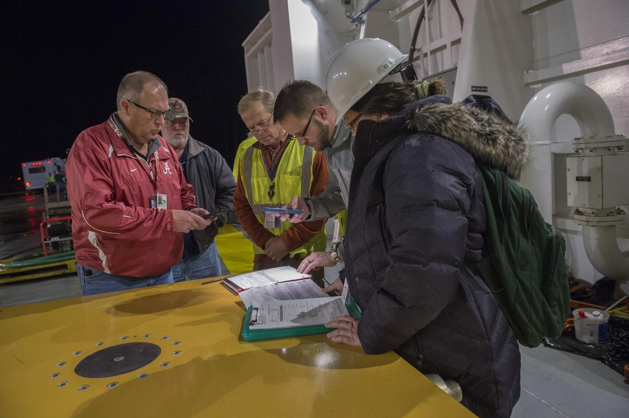 The SLS Stages Intertank Structural Test Assembly (STA) is rolling off the NASA Pegasus Barge at the MSFC Dock enroute to the MSFC 4619 Load Test Annex test facility for qualification testing
