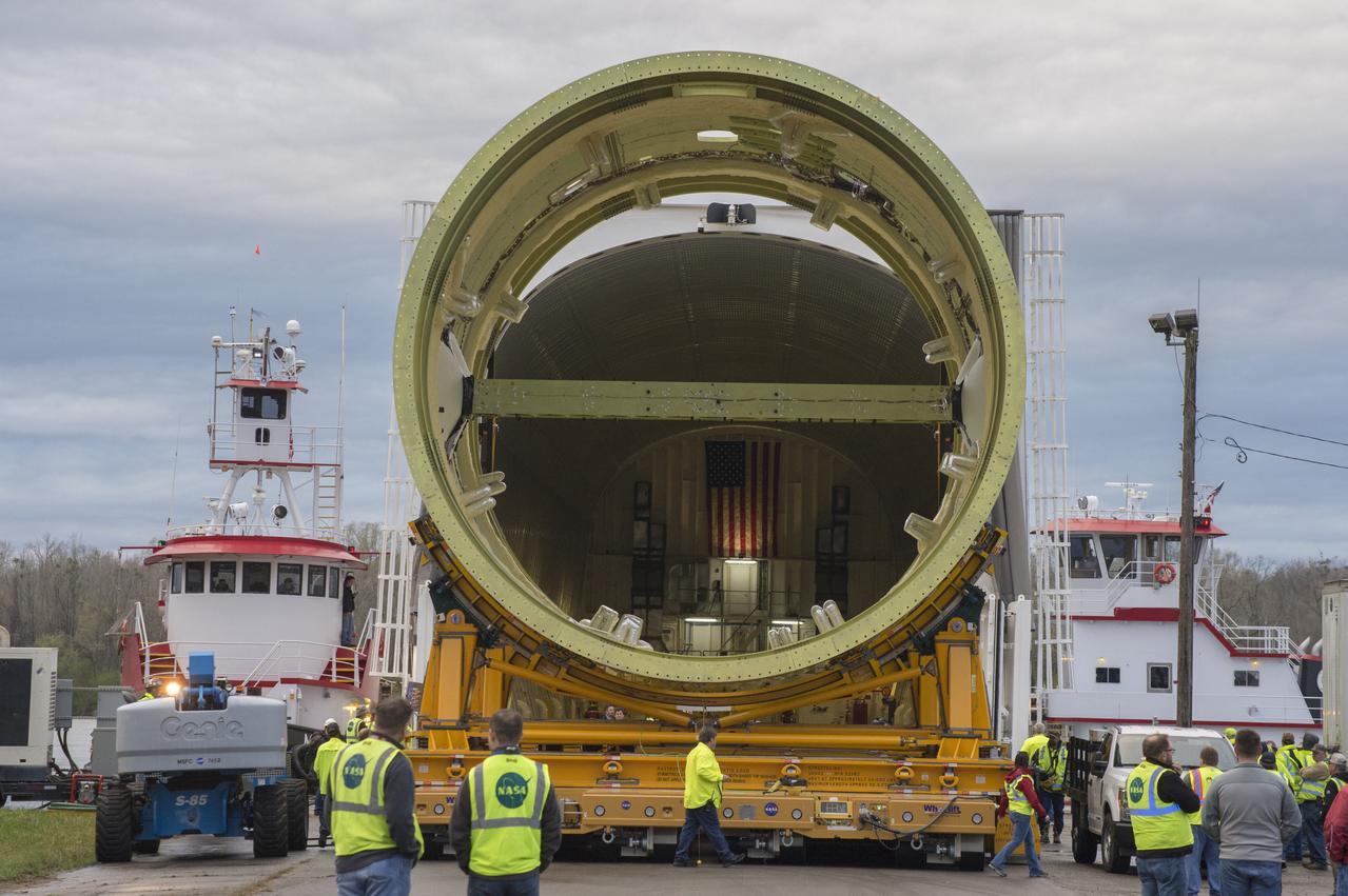 The SLS Stages Intertank Structural Test Assembly (STA) is rolling off the NASA Pegasus Barge at the MSFC Dock enroute to the MSFC 4619 Load Test Annex test facility for qualification testing. STA hardware completely free of barge and flanked by tug boats.