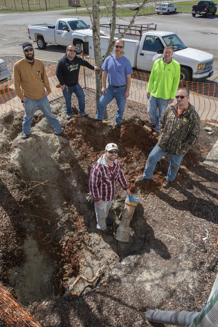 Members of Marshall's Facilities Operations and Maintenance Office team, including, clockwise from left, Robert Drane, Jeremy Holmes, Don Davis, team foreman Dusty Crouch, Wesley Brook and Lucas Broadway, gather to inspect and replace a pipe fitting. 