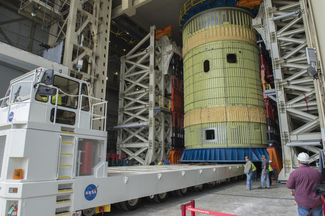 SLS Intertank Test Article, ITA, is attached to crosshead of load test Annex, Bldg. 4619, and removed from bed of KMAG transporter.  ITA is slowly raised from bed of KMAG transporter and KMAG is removed.