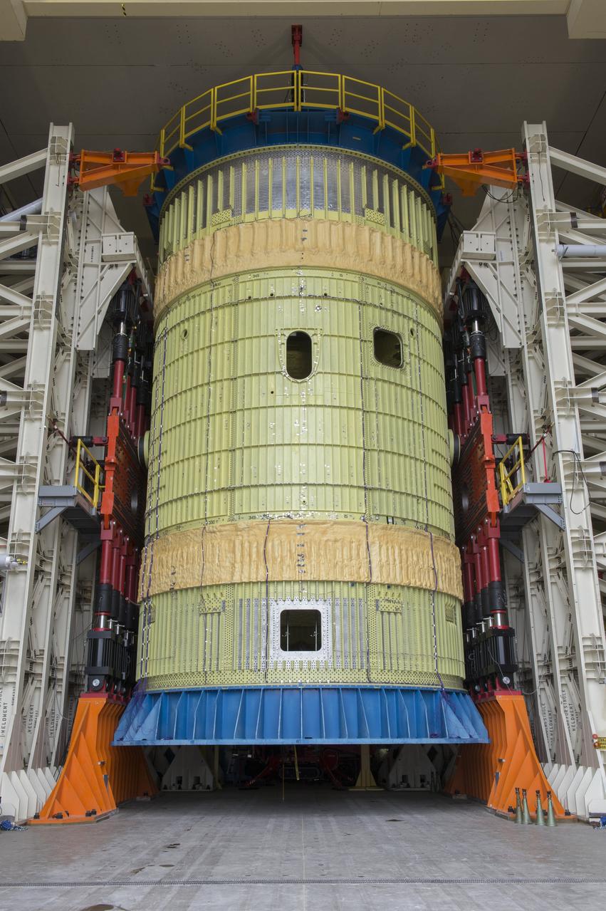 SLS Intertank Test Article, ITA, is attached to crosshead of load test Annex, Bldg. 4619, and removed from bed of KMAG transporter.  ITA is suspended from crosshead of Load Test Annex