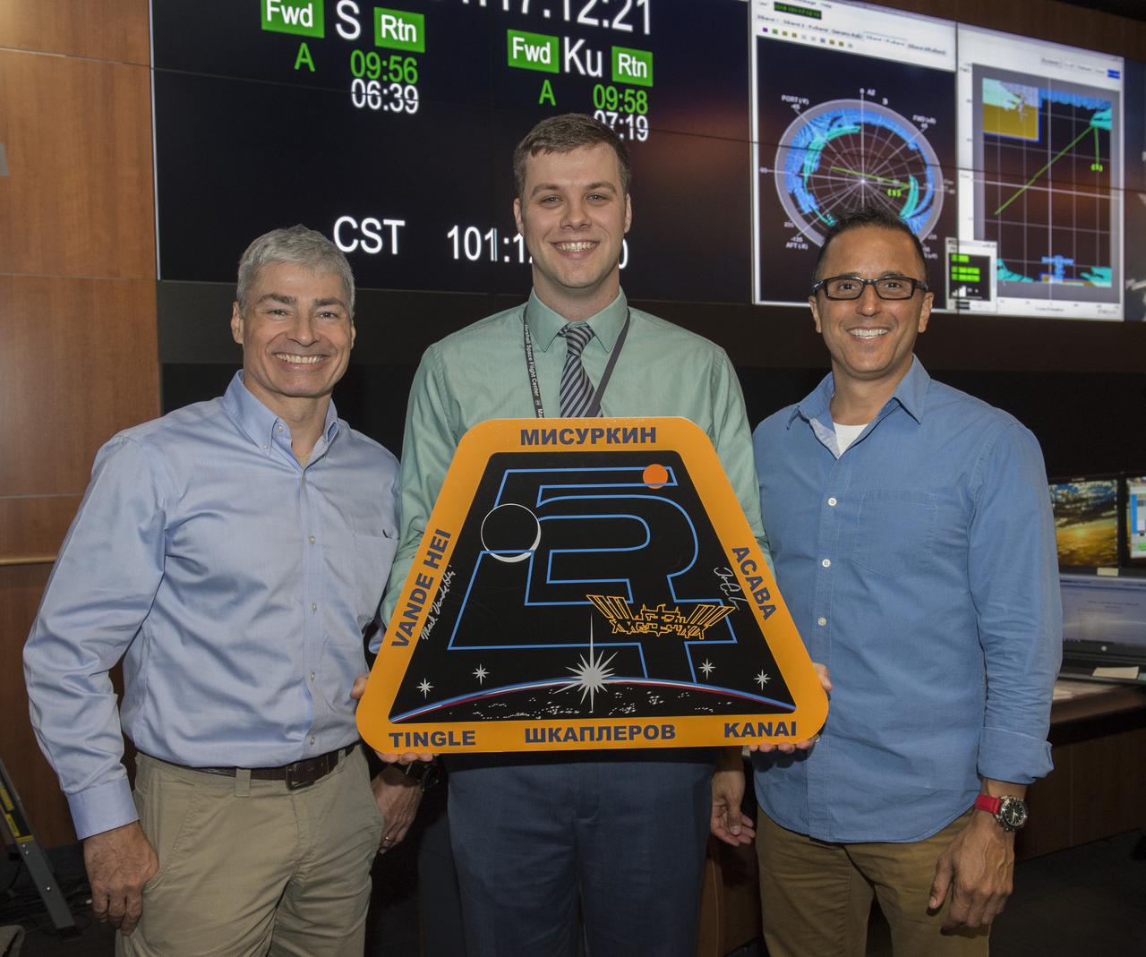 NASA astronauts Joe Acaba and Mark Vande Hei Acaba visited Marshall April 11 for their honorary Expedition 54 plaque hanging ceremony and to provide valuable feedback of their on-orbit science investigations with the Payload Operations and Integration Center team. Chris Buckley is awarded privilege of hanging Mission 54 placque, shown here with Astronaut Mark Vande Hei (L) and Astronaut Joe Acaba