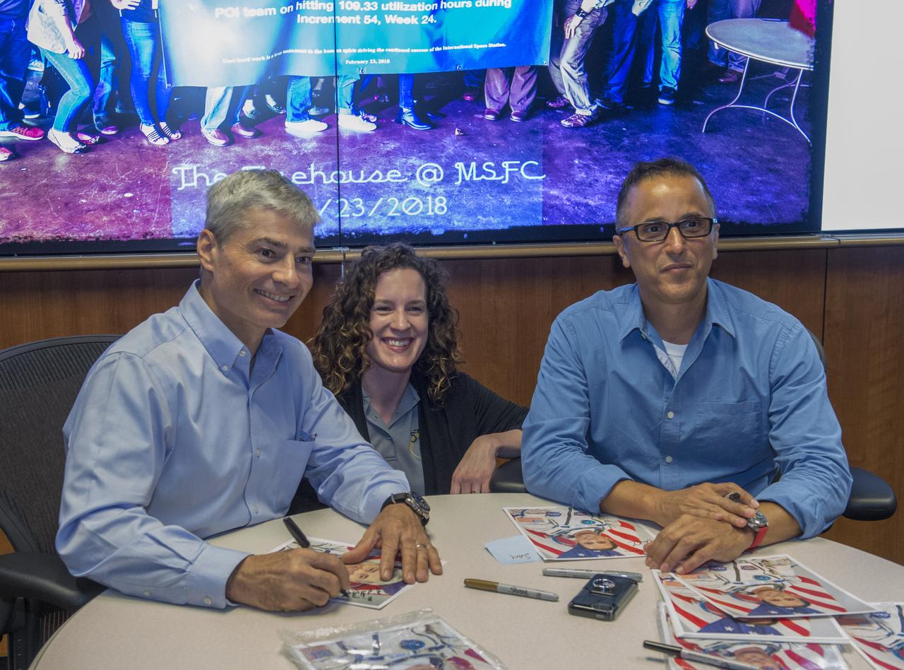 NASA astronauts Joe Acaba and Mark Vande Hei Acaba visited Marshall April 11 for their honorary Expedition 54 plaque hanging ceremony and to provide valuable feedback of their on-orbit science investigations with the Payload Operations and Integration Center team. Astronauts Mark Vande Hei (L) and Astronaut Joe Acaba sign autographs for Samantha Gurley.