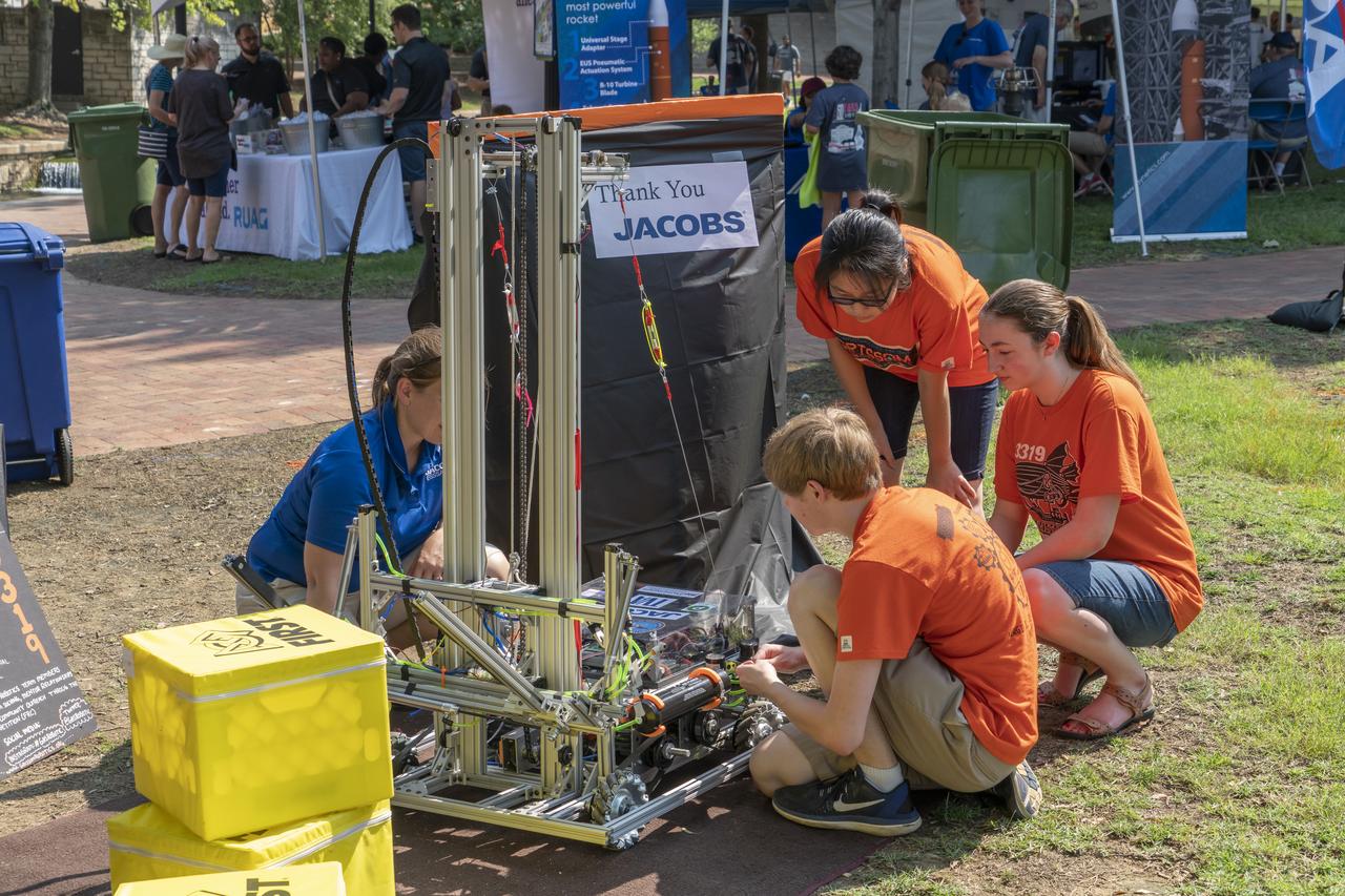 NASA's Marshall Space Flight Center showcased it's various projects for the public in Huntsville, Alabama's Big Spring Park. Exhibits were displayed by all of the various directorates of the Center with employee volunteers explaining all aspects of their projects. Adding to the festivities was the attendance of retired NASA astronaut Robert "Hoot" Gibson. Students from Huntsvilleâ€™s Grissom High School display their robot.
