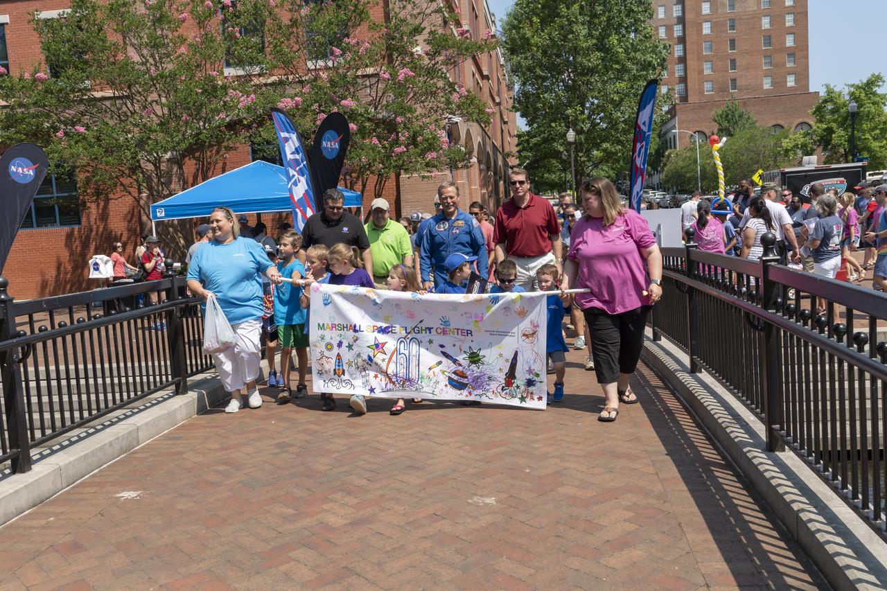 NASA's Marshall Space Flight Center showcased it's various projects for the public in Huntsville, Alabama's Big Spring Park. Exhibits were displayed by all of the various directorates of the Center with employee volunteers explaining all aspects of their projects. Adding to the festivities was the attendance of retired NASA astronaut Robert "Hoot" Gibson. The childrenâ€™s parade at NASA Day in the Park is led by center director Todd May, Chad Emerson, and Retired astronaut Robert â€œHootâ€ Gibson.