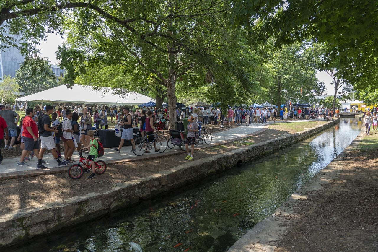 NASA's Marshall Space Flight Center showcased it's various projects for the public in Huntsville, Alabama's Big Spring Park. Exhibits were displayed by all of the various directorates of the Center with employee volunteers explaining all aspects of their projects. Adding to the festivities was the attendance of retired NASA astronaut Robert "Hoot" Gibson. A view of the canal running through the park showing a small portion of the crowd attending NASA Day in the Park.