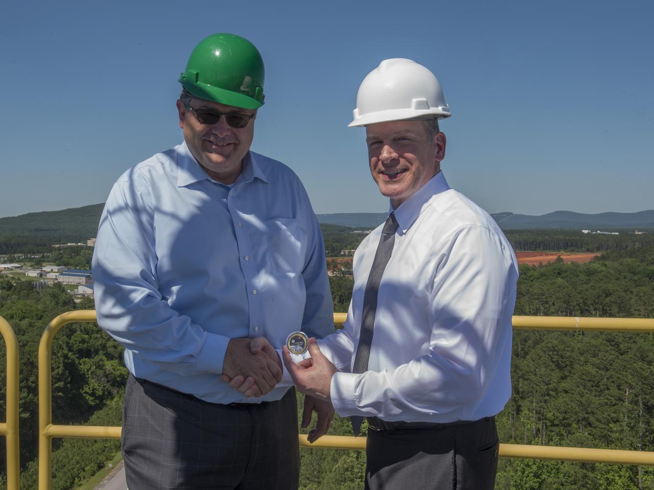MSFC Director Todd May presents token to FBI Associate Deputy Director Paul Abbate atop SLS Test Stand 4693