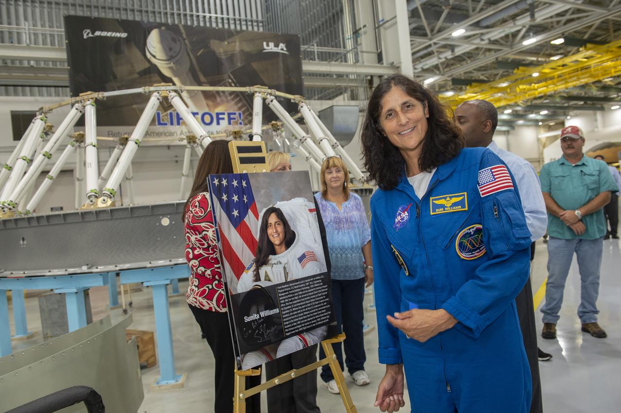 Astronaut Suni Williams poses with a poster of herself as she tours ULA facility in Decatur, Al
