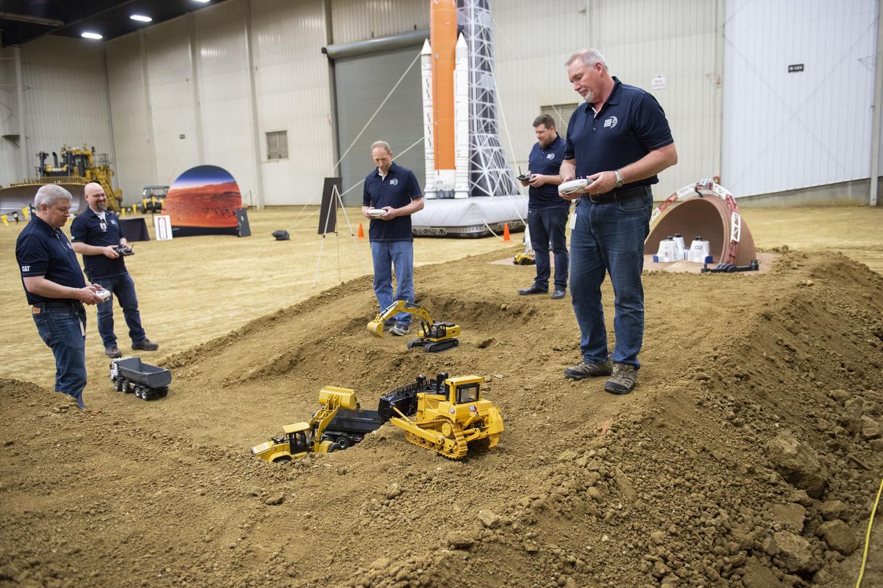AI. SpaceFactory of New York and Pennsylvania State University of College Park print subscale habitat structures at NASA's 3D-Printed Habitat Challenge, held at the Caterpillar Edwards Demonstration & Learning Center in Edwards, Illinois, May 1-4, 2019. The habitat print is the final level of the multi-phase competition, which began in in 2015. The challenge is managed by NASA's Centennial Challenges program, and partner Bradley University of Peoria, Illinois.  Caterpillar engineers work with specially modified radio controlled scale models that accurately replicate moves of full scale caterpillar equipment.  