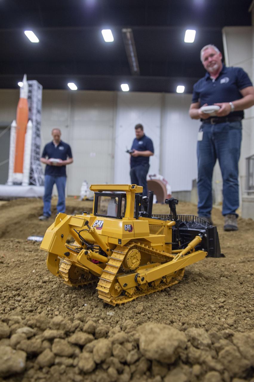 AI. SpaceFactory of New York and Pennsylvania State University of College Park print subscale habitat structures at NASA's 3D-Printed Habitat Challenge, held at the Caterpillar Edwards Demonstration & Learning Center in Edwards, Illinois, May 1-4, 2019. The habitat print is the final level of the multi-phase competition, which began in in 2015. The challenge is managed by NASA's Centennial Challenges program, and partner Bradley University of Peoria, Illinois.  Caterpillar engineers work with specially modified radio controlled scale models that accurately replicate moves of full scale caterpillar equipment.