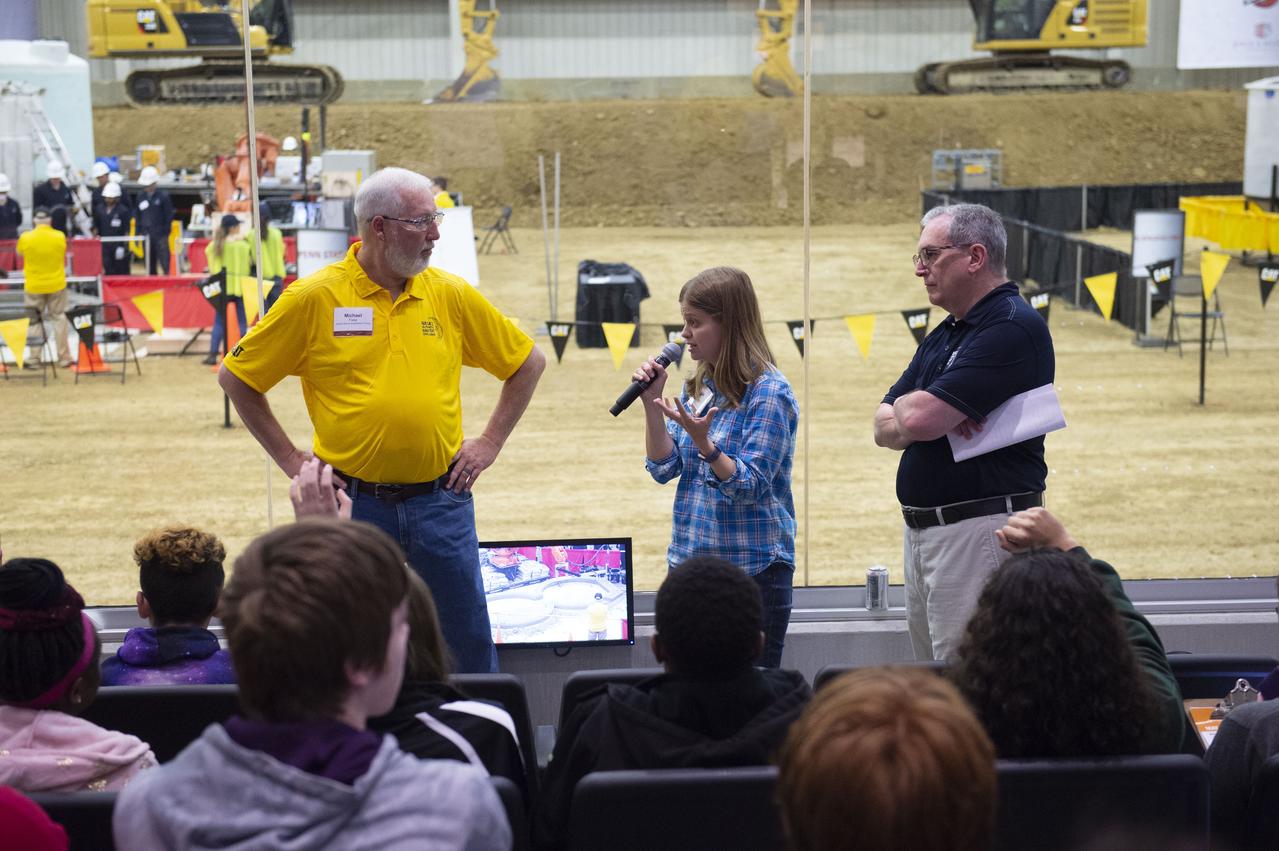AI. SpaceFactory of New York and Pennsylvania State University of College Park print subscale habitat structures at NASA's 3D-Printed Habitat Challenge, held at the Caterpillar Edwards Demonstration & Learning Center in Edwards, Illinois, May 1-4, 2019. The habitat print is the final level of the multi-phase competition, which began in in 2015. The challenge is managed by NASA's Centennial Challenges program, and partner Bradley University of Peoria, Illinois.  MSFC engineer Dr. Tracie Prater talks to public audience about the need for space habitat.