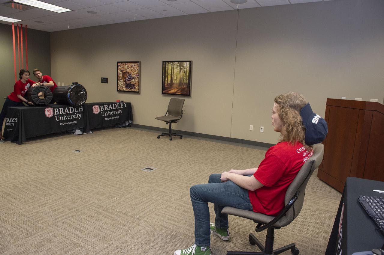 AI. SpaceFactory of New York and Pennsylvania State University of College Park print subscale habitat structures at NASA's 3D-Printed Habitat Challenge, held at the Caterpillar Edwards Demonstration & Learning Center in Edwards, Illinois, May 1-4, 2019. The habitat print is the final level of the multi-phase competition, which began in in 2015. The challenge is managed by NASA's Centennial Challenges program, and partner Bradley University of Peoria, Illinois.  Bradley University students demonstrate force produced by air cannon.