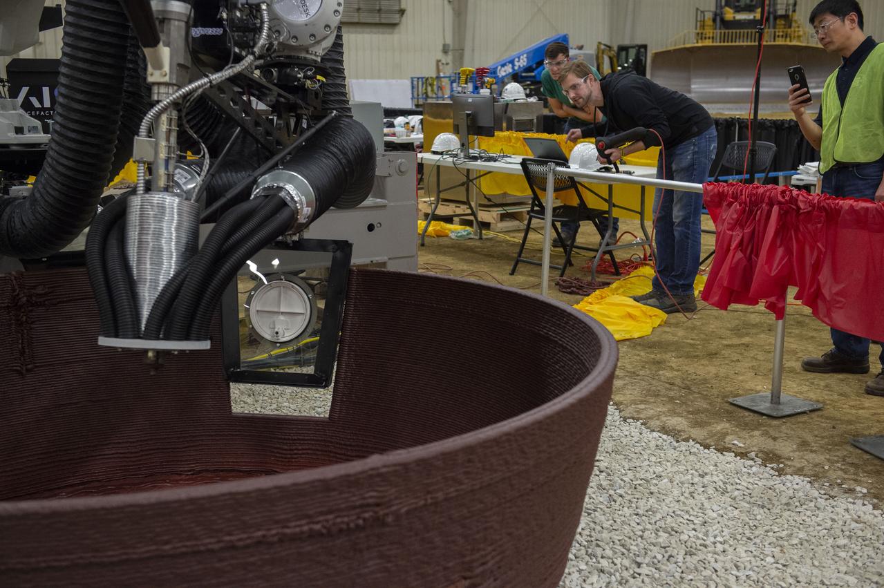 Team AI. SpaceFactory's printer autonomously inserts a window into their 3D-printed subscale habitat structure at NASA's 3D-Printed Habitat Challenge, held at the Caterpillar Edwards Demonstration & Learning Center in Edwards, Illinois, May 1-4, 2019. The habitat print is the final level of the multi-phase competition, which began in in 2015. The 3D-Printed Habitat Challenge is a competition to create sustainable shelters suitable for the Moon, Mars or beyond using resources available on-site in these locations. The challenge is managed by NASA's Centennial Challenges program, and partner Bradley University of Peoria, Illinois.