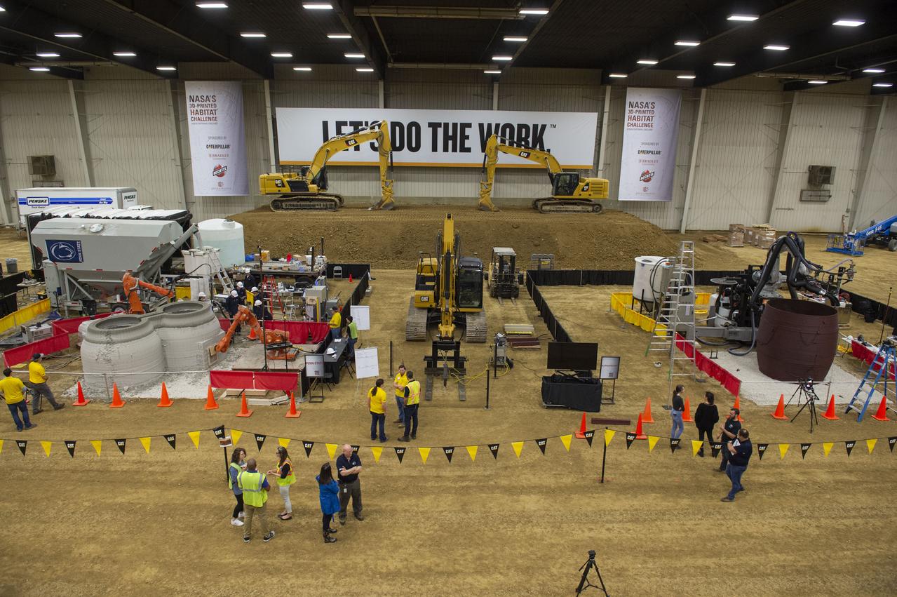 Two teams - Penn State (left) and AI. SpaceFactory (right) competed to 3D-print subscale habitat structures at NASA's 3D-Printed Habitat Challenge, held at the Caterpillar Edwards Demonstration & Learning Center in Edwards, Illinois, May 1-4, 2019. The habitat print is the final level of the multi-phase competition, which began in in 2015. The 3D-Printed Habitat Challenge is a competition to create sustainable shelters suitable for the Moon, Mars or beyond using resources available on-site in these locations. The challenge is managed by NASA's Centennial Challenges program, and partner Bradley University of Peoria, Illinois.