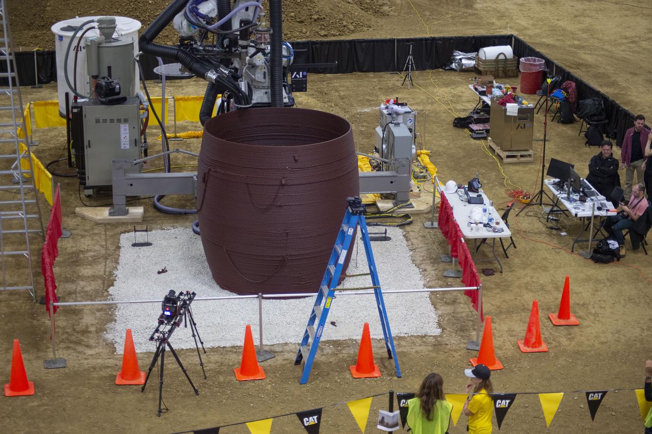 Team AI. SpaceFactory's subscale habitat structure about two-thirds complete at NASA's 3D-Printed Habitat Challenge, held at the Caterpillar Edwards Demonstration & Learning Center in Edwards, Illinois, May 1-4, 2019. The habitat print is the final level of the multi-phase competition, which began in in 2015. The 3D-Printed Habitat Challenge is a competition to create sustainable shelters suitable for the Moon, Mars or beyond using resources available on-site in these locations. The challenge is managed by NASA's Centennial Challenges program, and partner Bradley University of Peoria, Illinois.