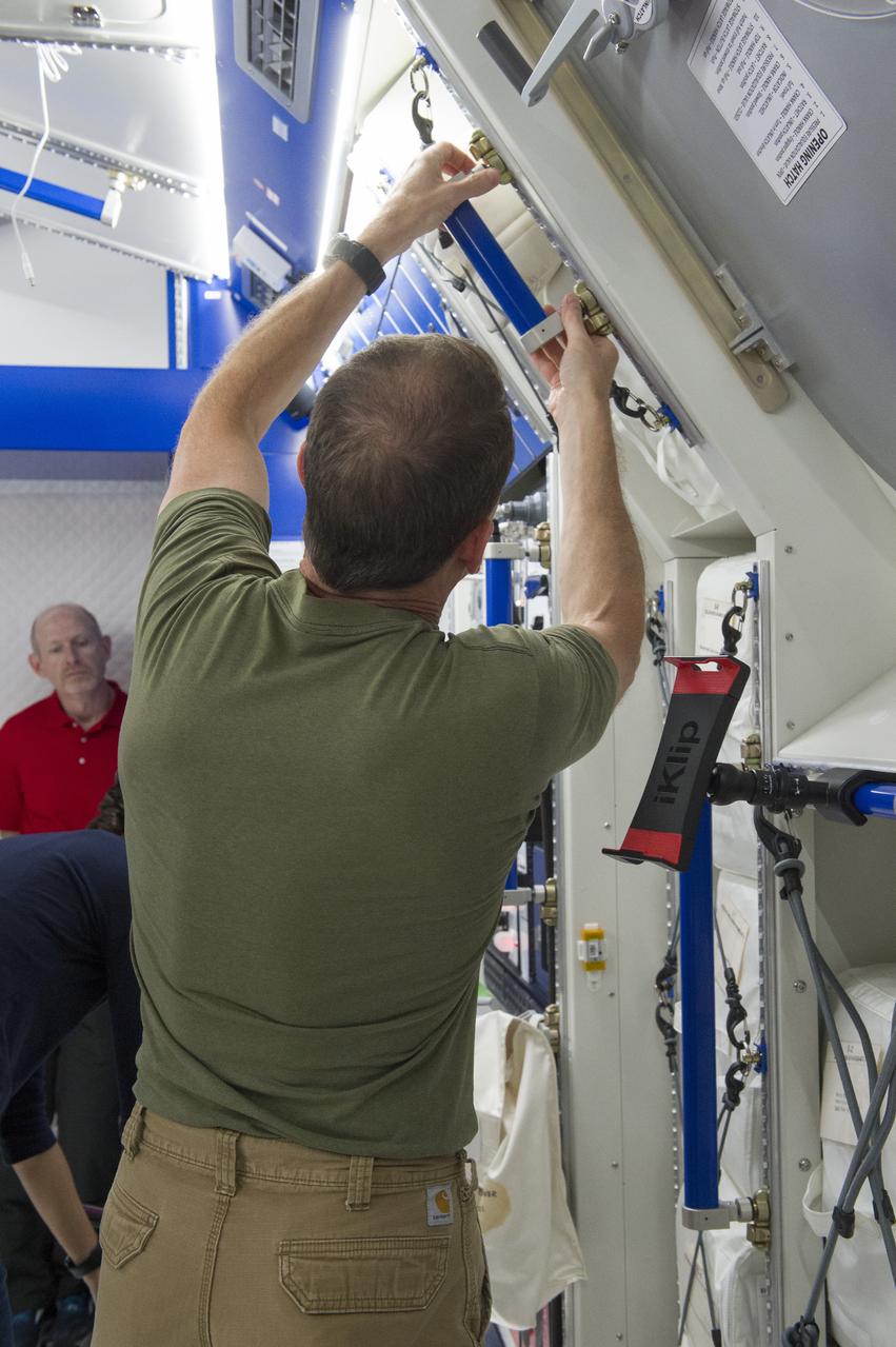 Boeing trainers conduct simulations inside the Boeing Exploration Habitat Demonstrator with astronauts to evaluate the internal layout and ergonomics, to support efficient work-life balance aboard a deep space ship.