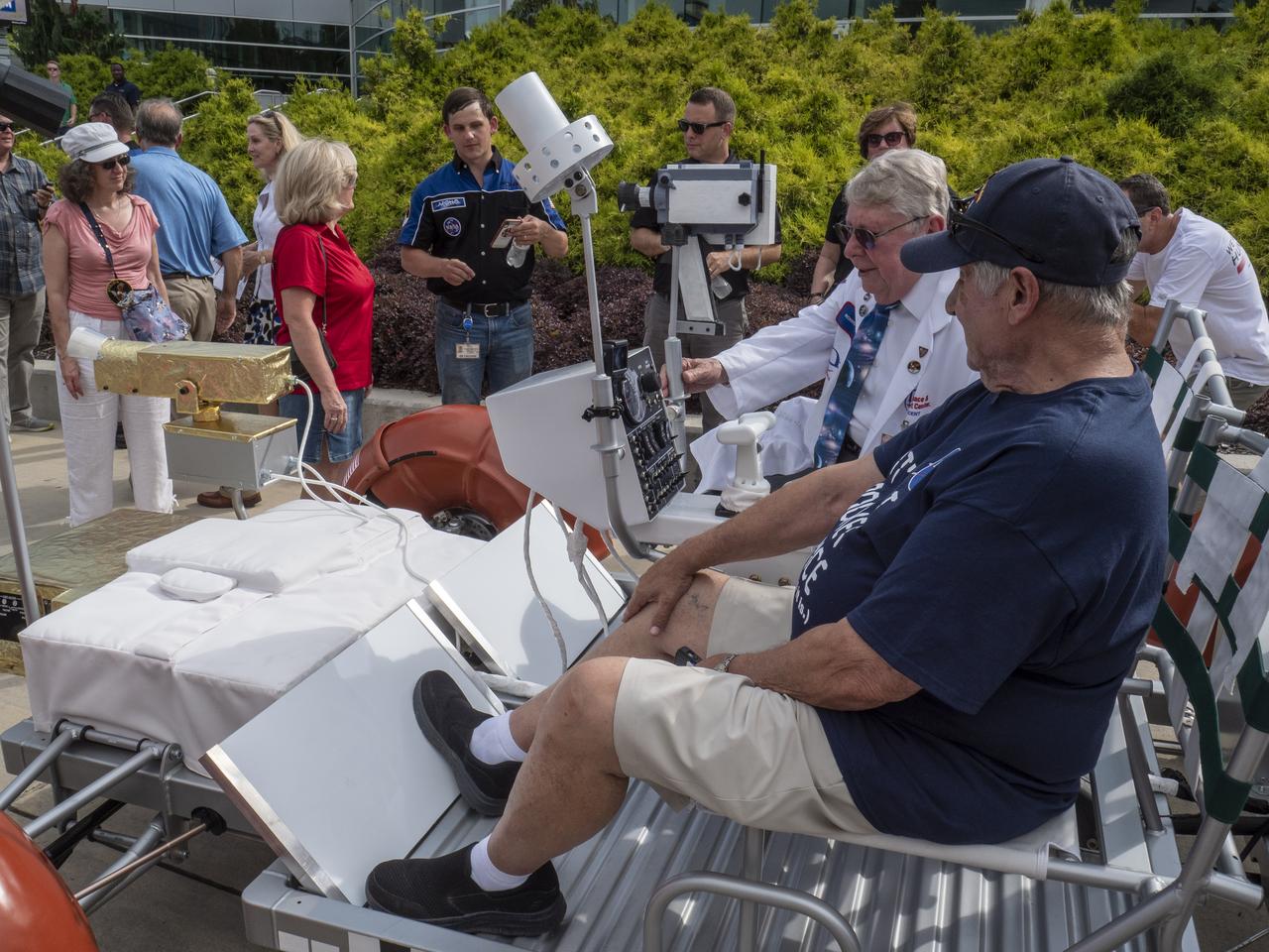 The City of Huntsville hosted a celebration of the Apollo 11 Moon landing with a street party on the downtown square with exhibits from the Marshall Space Flight Center and contributing contractors. The event was kicked off with remarks from Huntsville Mayor Tommy Battle, Marshall Space Flight Center's Director Jody Singer, and U.S. Space and Rocket Center's Director Deborah Barnhart with the Polaris replica of the Lunar Moon Buggy in the foreground. Retired engineers Sonny Morea and Richard Hoover sit in the Polaris Lunar Rover replica.