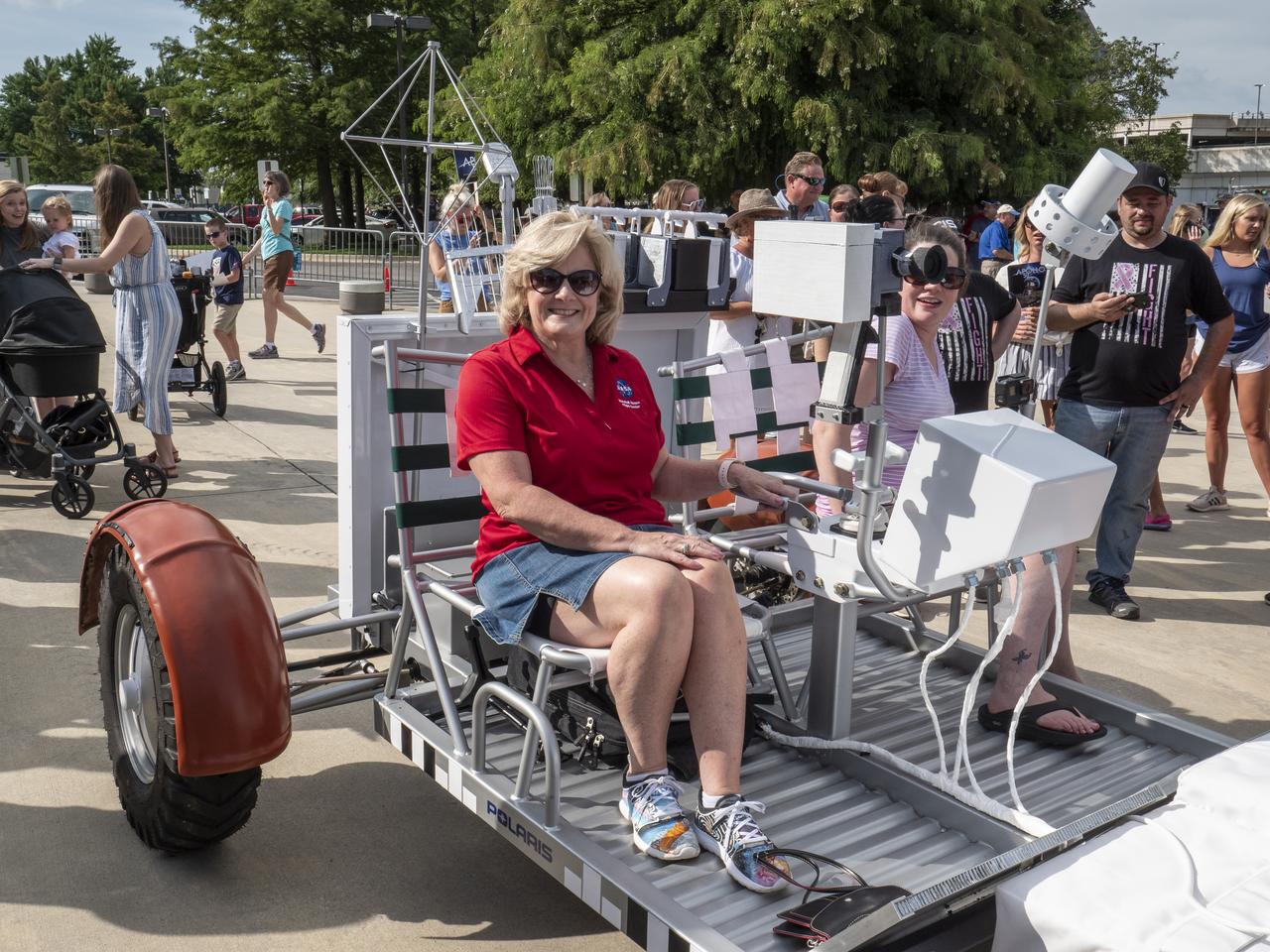 The City of Huntsville hosted a celebration of the Apollo 11 Moon landing with a street party on the downtown square with exhibits from the Marshall Space Flight Center and contributing contractors. The event was kicked off with remarks from Huntsville Mayor Tommy Battle, Marshall Space Flight Center's Director Jody Singer, and U.S. Space and Rocket Center's Director Deborah Barnhart with the Polaris replica of the Lunar Moon Buggy in the foreground. Marshall Center Director Jody Singer sits in the Polaris Lunar Rover replica.