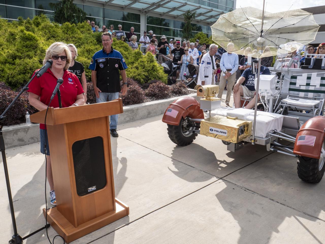 The City of Huntsville hosted a celebration of the Apollo 11 Moon landing with a street party on the downtown square with exhibits from the Marshall Space Flight Center and contributing contractors. The event was kicked off with remarks from Huntsville Mayor Tommy Battle, Marshall Space Flight Center's Director Jody Singer, and U.S. Space and Rocket Center's Director Deborah Barnhart with the Polaris replica of the Lunar Moon Buggy in the foreground. Marshall Center Director Jody Singer addresses the crowd.