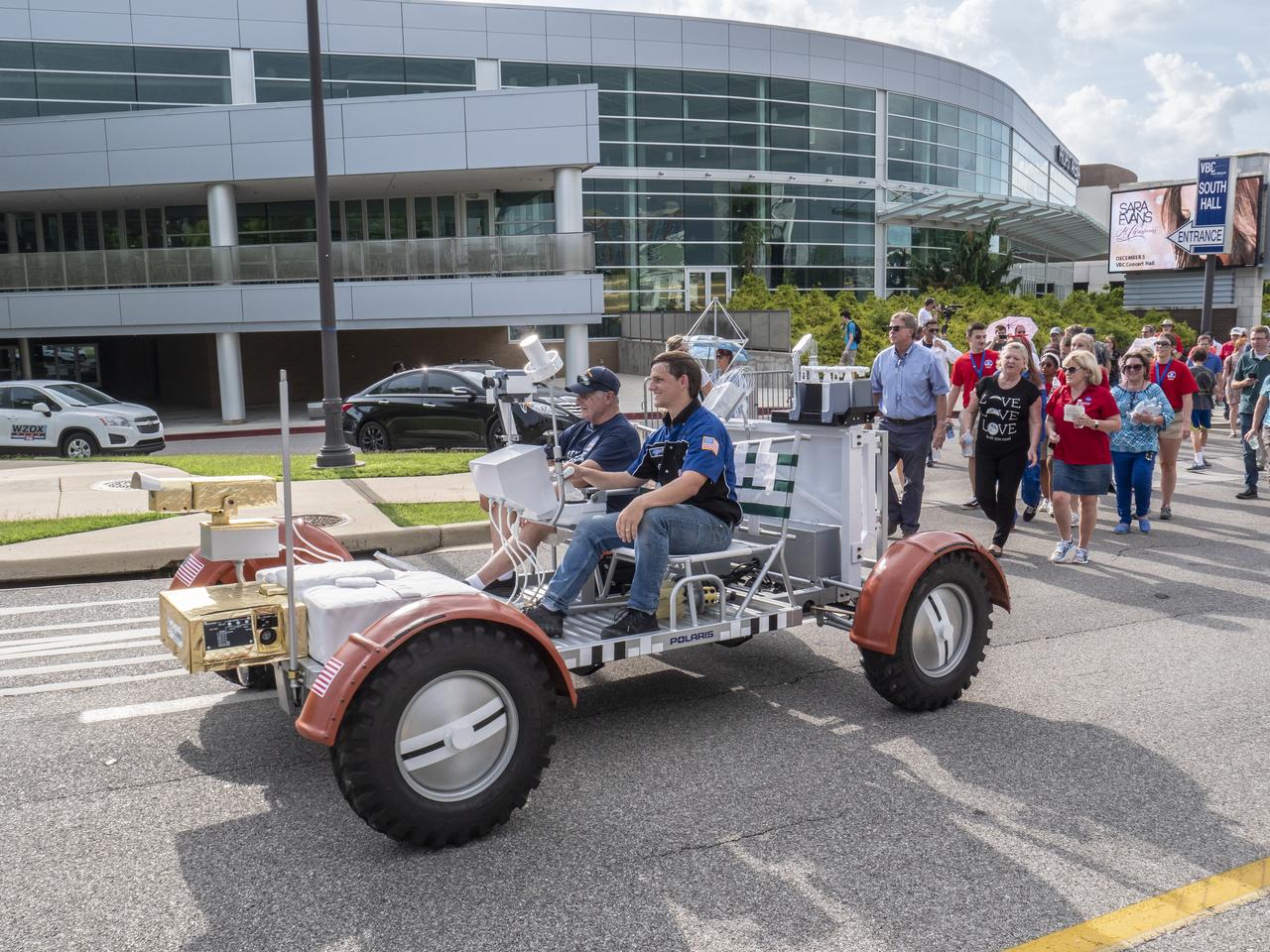 The City of Huntsville hosted a celebration of the Apollo 11 Moon landing with a street party on the downtown square with exhibits from the Marshall Space Flight Center and contributing contractors. The event was kicked off with remarks from Huntsville Mayor Tommy Battle, Marshall Space Flight Center's Director Jody Singer, and U.S. Space and Rocket Center's Director Deborah Barnhart with the Polaris replica of the Lunar Moon Buggy in the foreground. The Lunar Rover replica, followed by MSFC Director Jody Singer, USSRC Director Deborah Barnhart, and May Tommy Battle lead the parade to the Huntsville square.