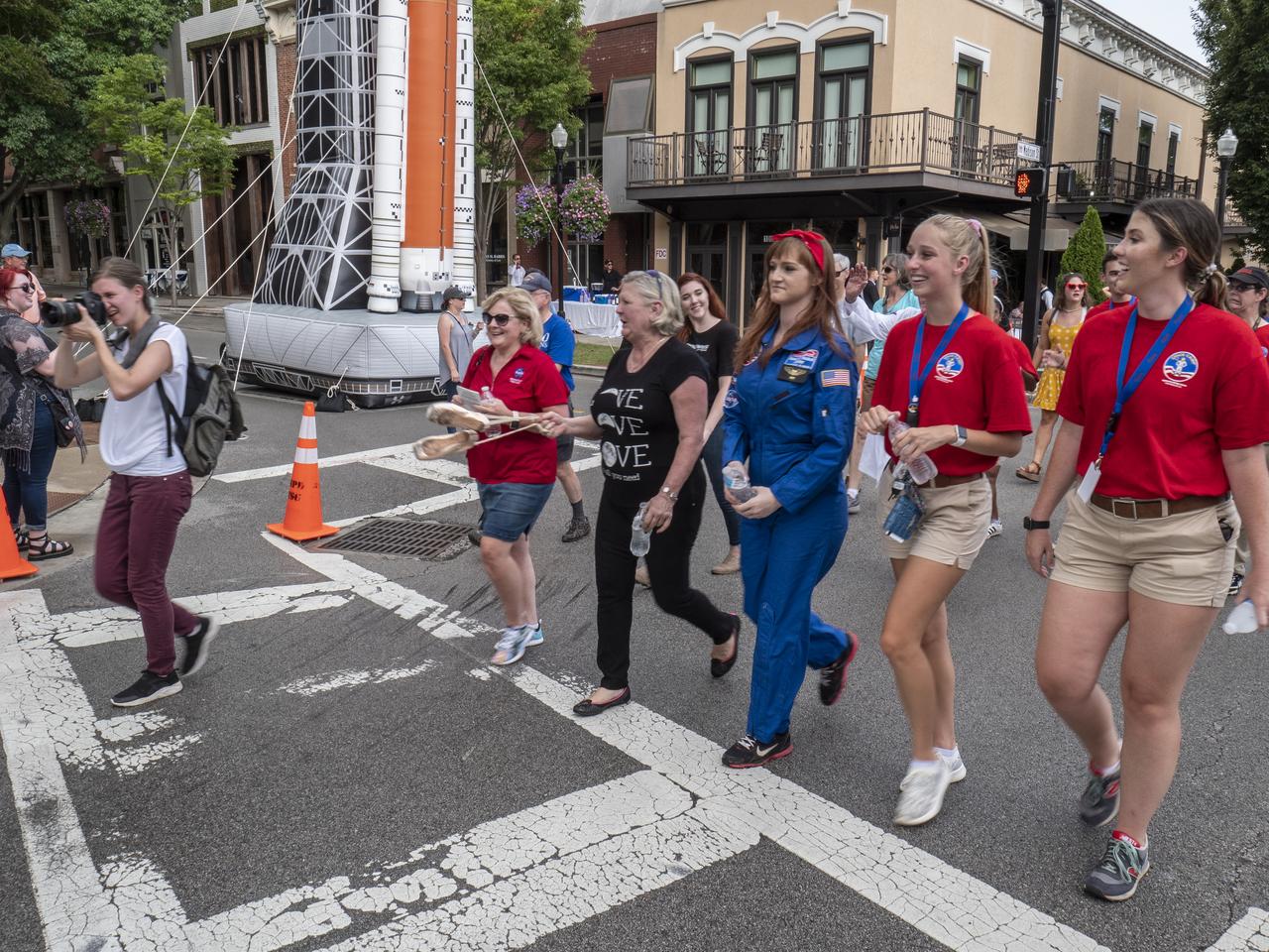 The City of Huntsville hosted a celebration of the Apollo 11 Moon landing with a street party on the downtown square with exhibits from the Marshall Space Flight Center and contributing contractors. The event was kicked off with remarks from Huntsville Mayor Tommy Battle, Marshall Space Flight Center's Director Jody Singer, and U.S. Space and Rocket Center's Director Deborah Barnhart with the Polaris replica of the Lunar Moon Buggy in the foreground. MSFC Director Jody Singer and U.S. Space and Rocket Center Director Deborah Barnhart lead the parade into the Huntsville Square.