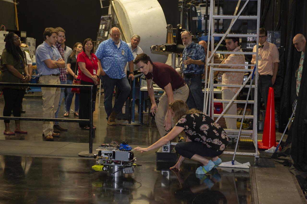  PATHWAYS INTERN ALEXANDRA BOEHM, AND JACOBS INTERN, PEYTON NELSON DEMONSTRATE STEERABLE AIR BEARING TETHER DEPLOYMENT SYSTEM TO MSFC SENIOR MANAGEMENT. ALSO WORKING ON THE PROJECT BUT NOT PICTURED WERE SUMMER INTERN ALI BERTELSMAN, PATHWAYS INTERN ANNA SHIPMAN, AND JACOBS FULL-TIME EMPLOYEE BRANDON MOORE.