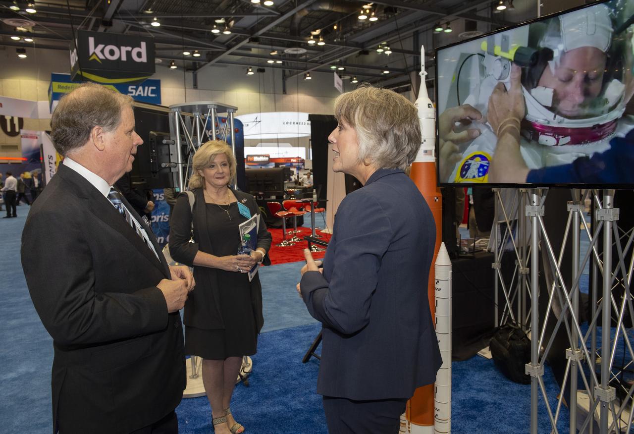 Sen. Doug Jones of Alabama, left, and Marshall Space Flight Center Director Jody Singer, center, talk with Marcia Lindstrom, Strategic Communications Manager for NASA’s Space Launch System, Aug. 7 at the annual Space & Missile Defense Symposium in Huntsville, Alabama. The SLS is the world’s most powerful rocket, and will be the backbone for deep space exploration as NASA’s Artemis program advances. 