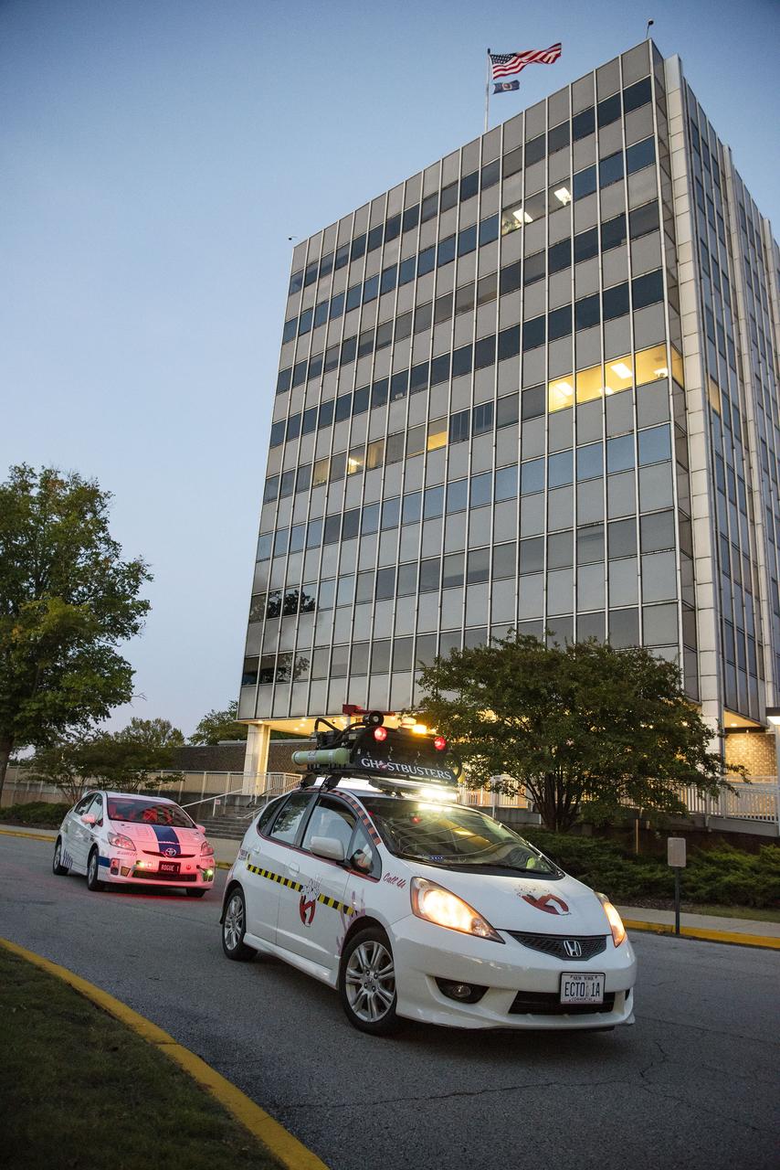 Andrew Denio, a Marshall information technology specialist in the Office of the Chief Information Officer, and Judson Hudson, a lab technician and computer-aided designer in Marshall’s Valve & Component Laboratory, show off their Ghostbusters and Star Wars themed vehicles in front of MSFC building 4200, for Halloween 2019. 
