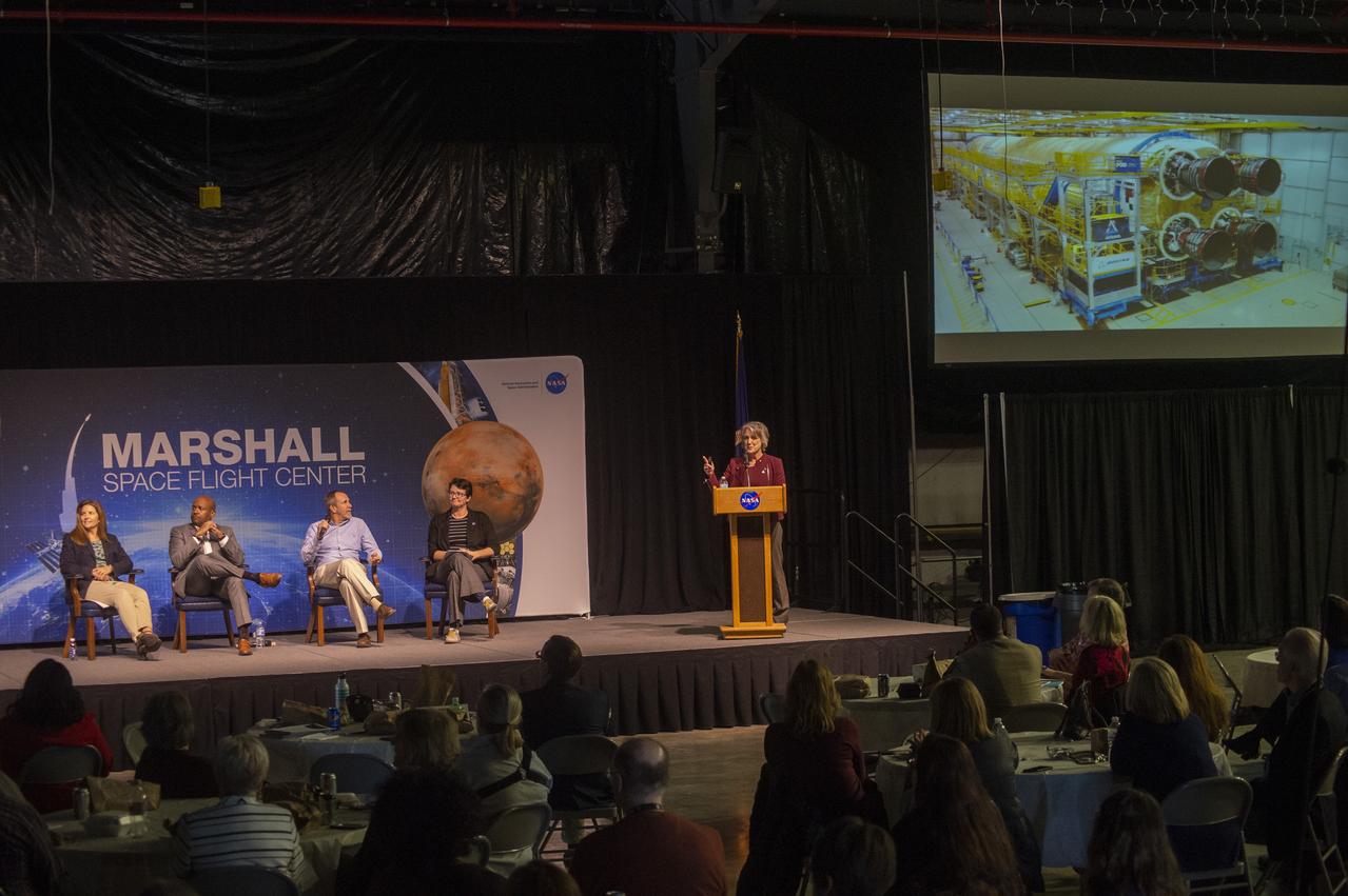 MARCIA LINDSTROM, AT PODIUM, FACILITATES ARTEMIS PROGRAM PANEL DISCUSSION AT NOVEMBER MARSHALL ASSOCIATION LUNCHEON.   (L TO R),  LISA WATSON-MORGAN, PROGRAM MANAGER, HUMAN LANDING SYSTEM;  BOBBY WATKINS, DIRECTOR HUMAN EXPLORATION DEVELOPMENT & OPERATIONS OFFICE;  DAVID BEAMAN, MANAGER, SYSTEMS ENGINEERING & INTEGRATION OFFICE, RENEE WEBER, ACTING CENTER CHIEF SCIENTIST