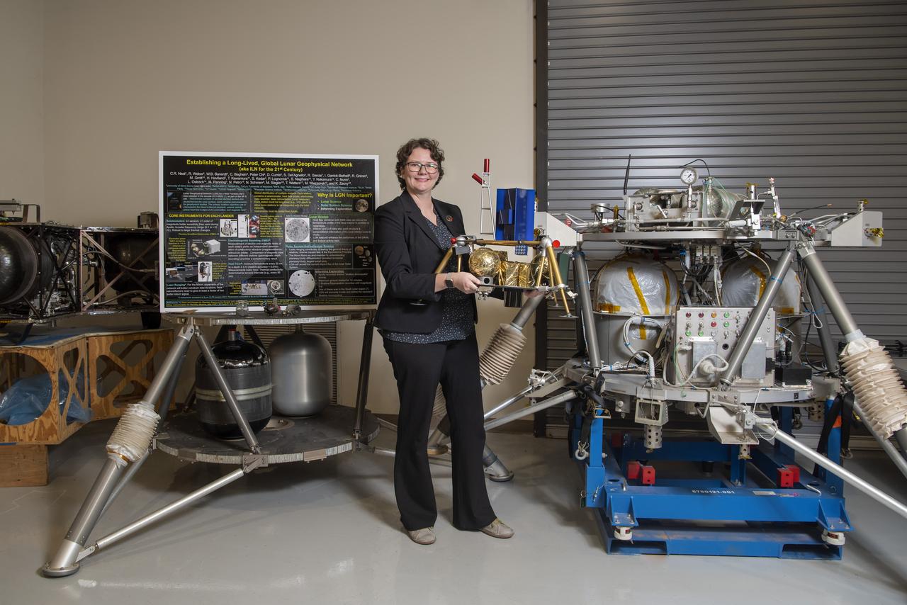Environmental portrait of Renee Weber, commemorating her recent transition to the MSFC Chief Scientist position. Pictured with lunar lander models in the lander lab building 4747.
