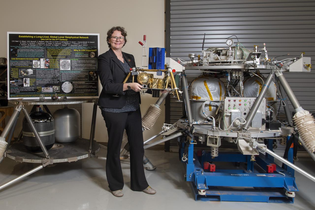 Environmental portrait of Renee Weber, commemorating her recent transition to the MSFC Chief Scientist position. Pictured with lunar lander models in the lander lab building 4747.