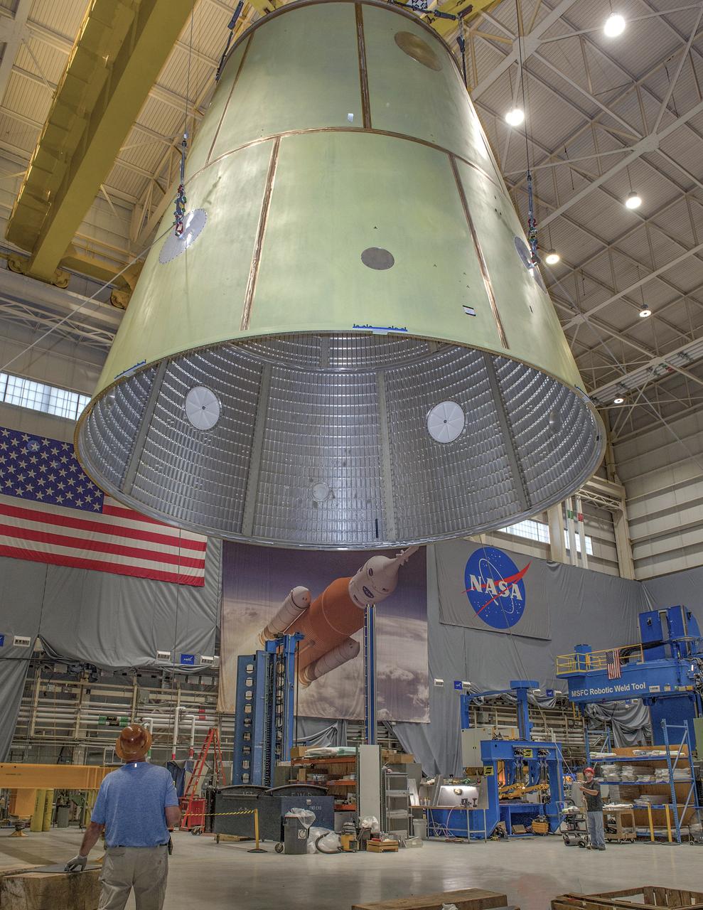 Lifting of the Launch Vehicle Stage Adapter (LVSA) in preparation for transport. The LVSA was fabricated in the EM32 Advanced Welding Development Facility at the NASA George C. Marshall Space Flight Center. The LVSA was welded using the conventional and self-reacting friction stir process and has approximately 375 feet of weld.