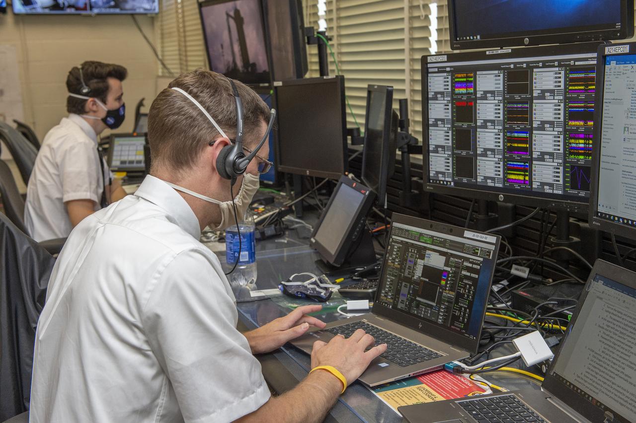 Stewart Whaley, Cameron Muelling, foreground, and teams at NASA’s Marshall Space Flight Center help monitor launch conditions for the Demo-2 mission from the Huntsville Operations Support Center, HOSC.