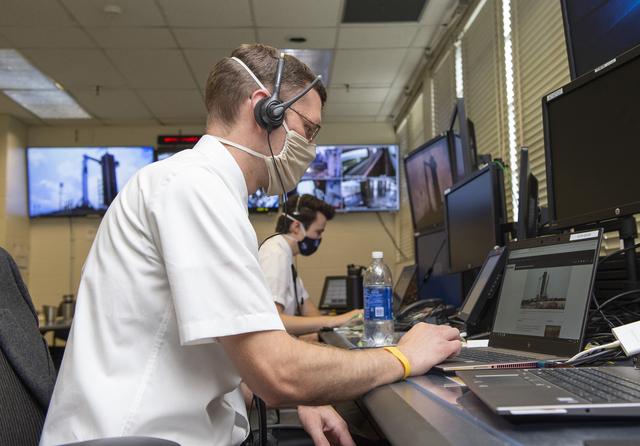 Stewart Whaley, Cameron Muelling, foreground, and teams at NASA’s Marshall Space Flight Center help monitor launch conditions for the Demo-2 mission from the Huntsville Operations Support Center, HOSC.