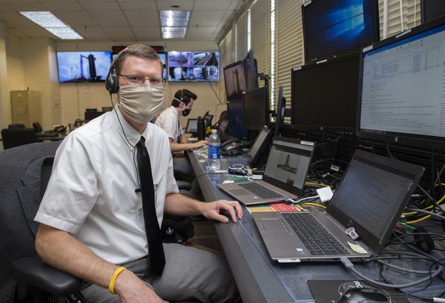 Stewart Whaley, Cameron Muelling, foreground, and teams at NASA’s Marshall Space Flight Center help monitor launch conditions for the Demo-2 mission from the Huntsville Operations Support Center, HOSC.