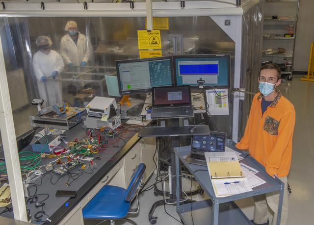 NASA image: Spacecraft in Gravity Off-load Fixture (GOLF), System Test configuration - Arisa Waddle – Test Engineer,  Rick Wilson – Lead Test Engineer