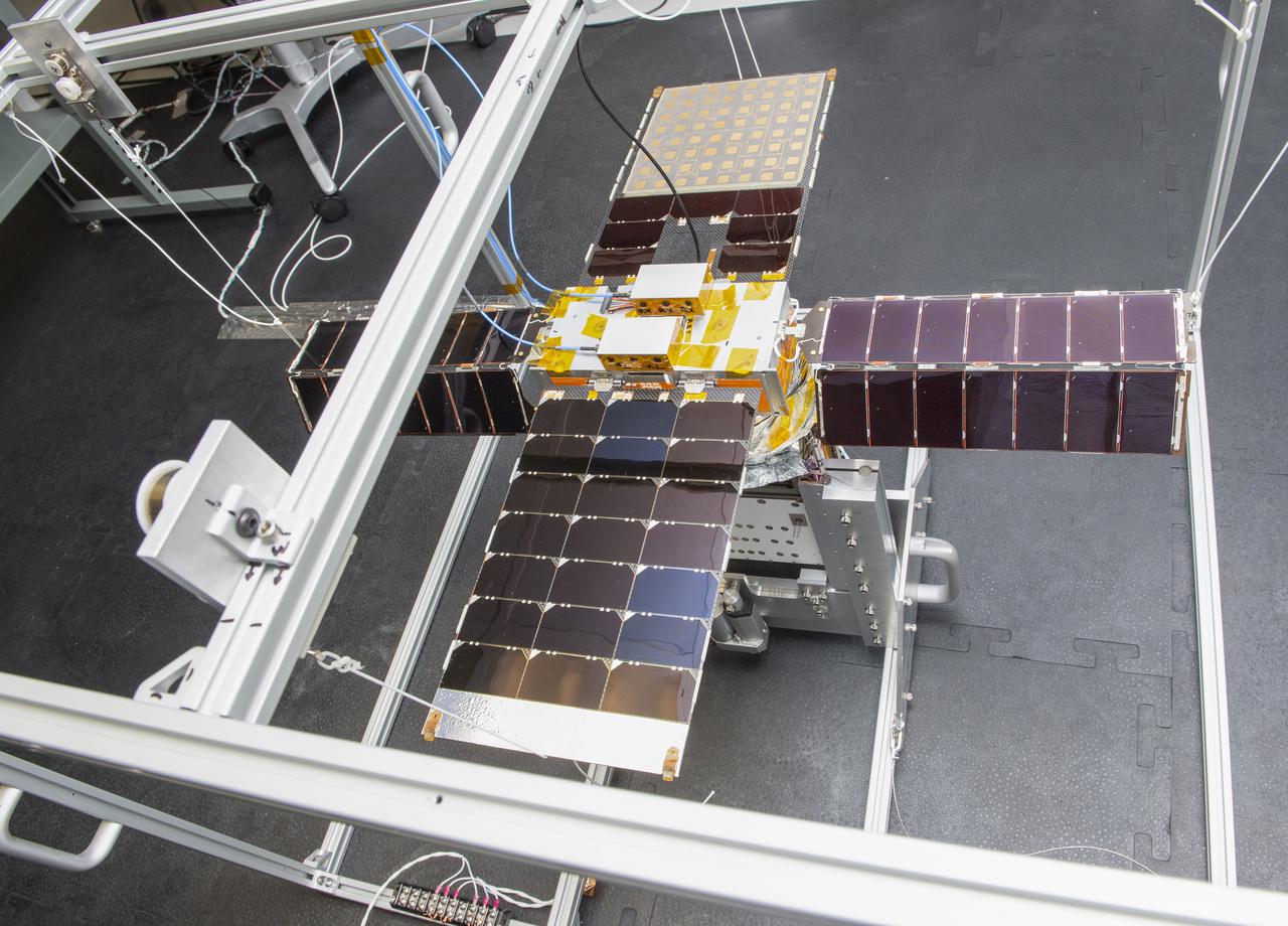 Spacecraft in Gravity Off-load Fixture (GOLF), System Test configuration - Arisa Waddle – Test Engineer,  Rick Wilson – Lead Test Engineer