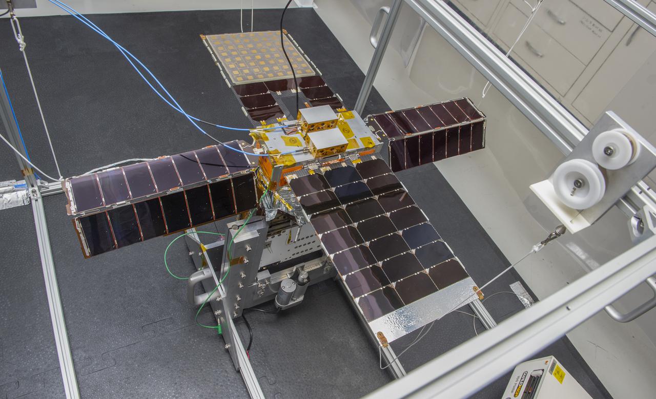 Spacecraft in Gravity Off-load Fixture (GOLF), System Test configuration - Arisa Waddle – Test Engineer,  Rick Wilson – Lead Test Engineer